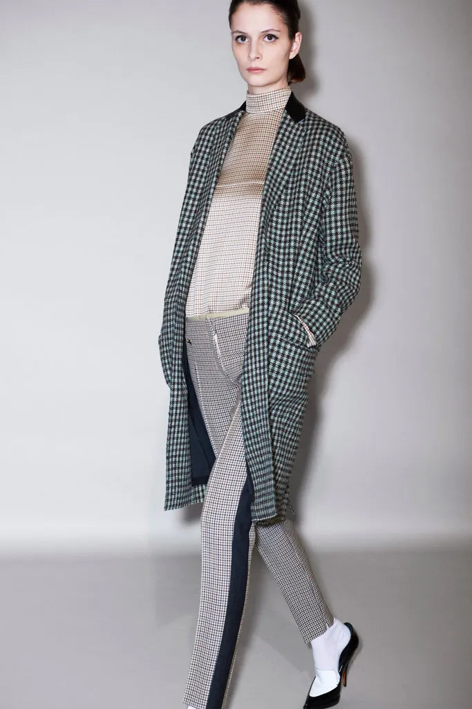 Celine Pre-Fall 2011 Phoebe Philo runway coat in neutral fabric, displayed on a runway with model and background.