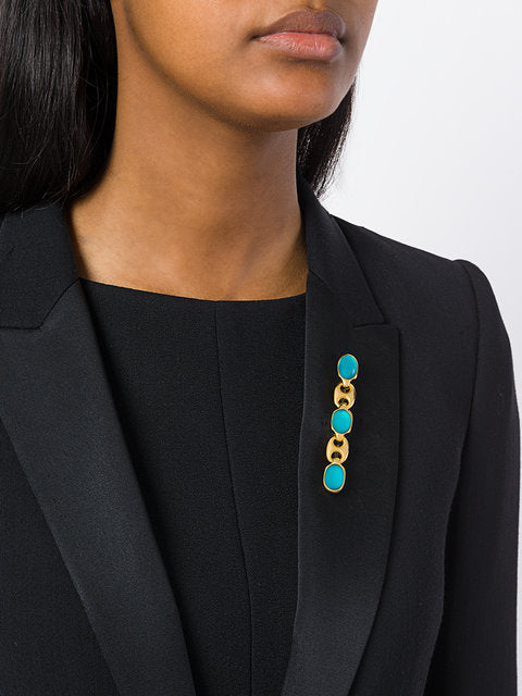 Gucci vintage link and lucite brooch featuring a stylish, retro design with clear lucite and metal accents.