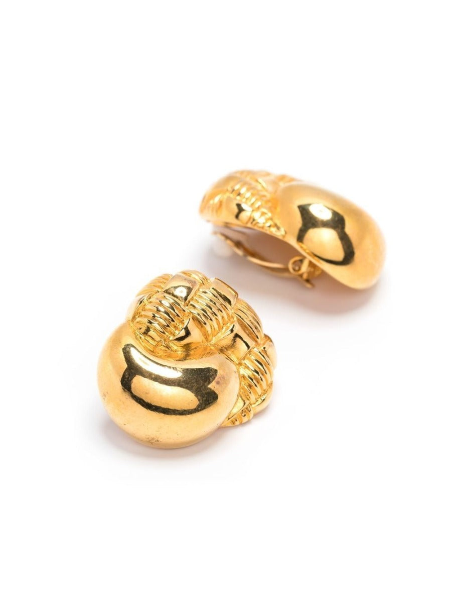 Gold-tone horn motif clip-on earrings by Celine featuring bold, artistic horn-shaped design on shiny gold finish.