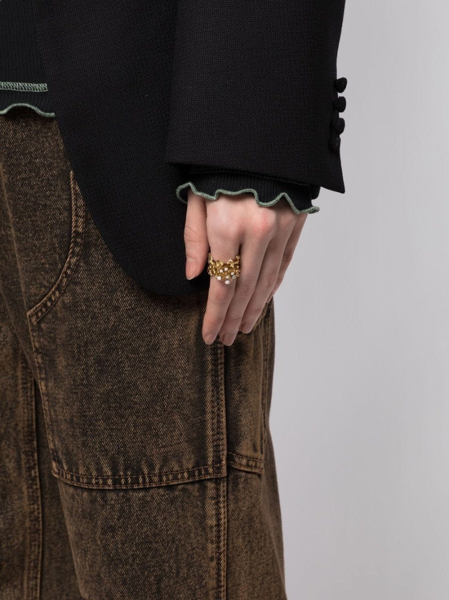Vintage Finds 1970s gold diamond openwork ring with intricate design and sparkling diamonds on a neutral background.