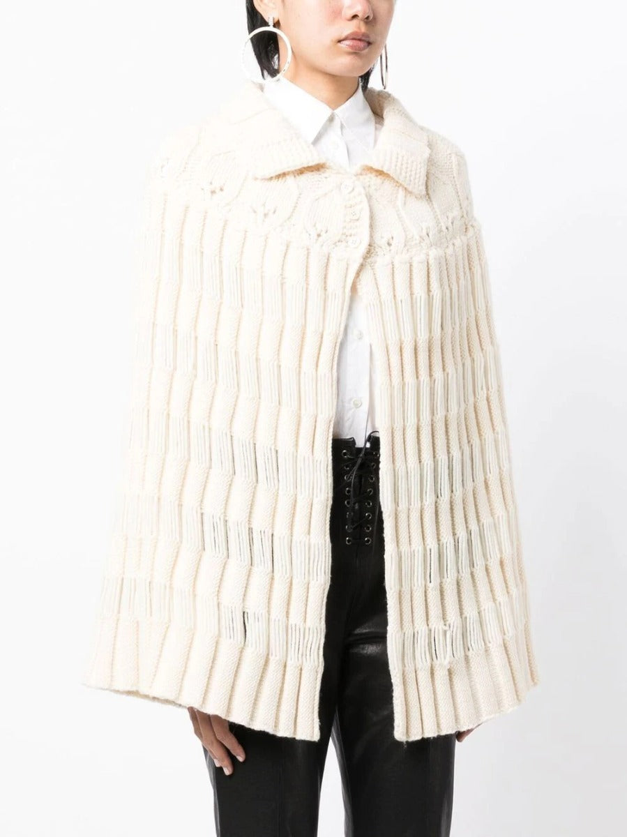 Saint Laurent chunky knit crochet poncho, stylish blazer-style jacket with textured knit pattern and relaxed fit.