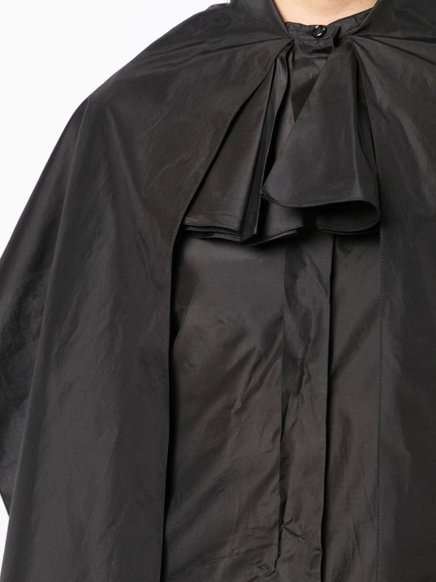 Black layered silk blouse from Yves Saint Laurent, stylish top with a flowing cape design and elegant fabric detail.