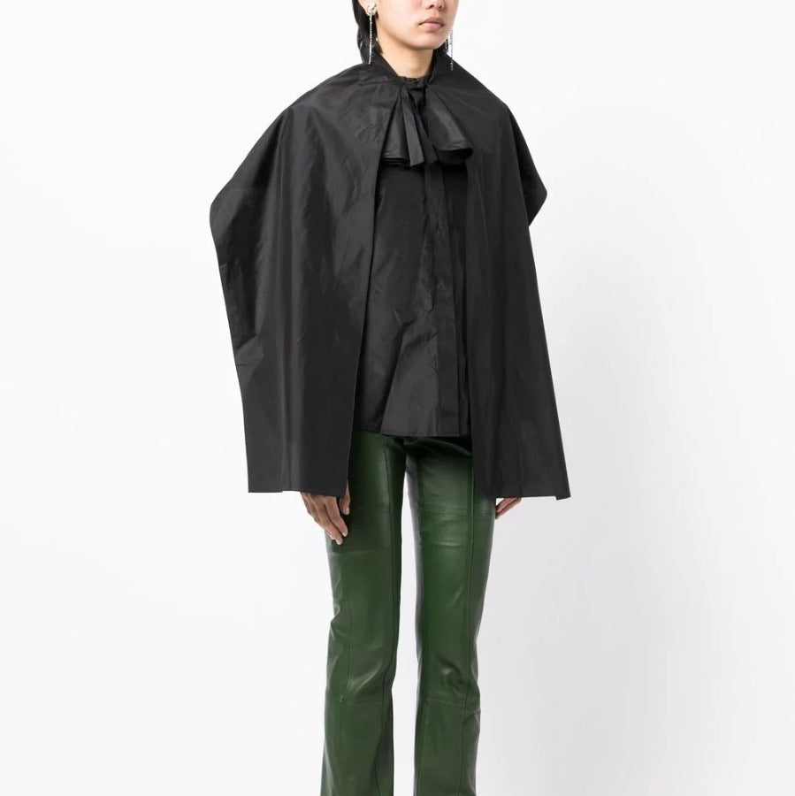 Black layered silk blouse from Yves Saint Laurent, stylish top with flowing fabric and elegant design.