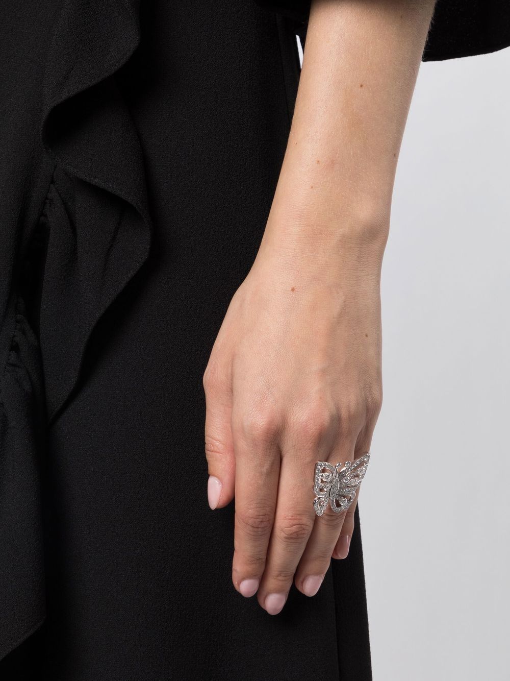 Van Cleef & Arpels butterfly ring featuring intricate metalwork and gemstone accents, showcasing elegance and craftsmanship.