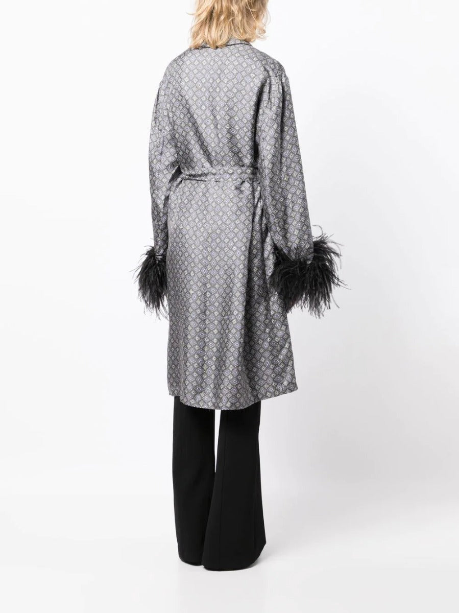 Prada silk robe with feather detailing, stylish and luxurious loungewear, shown in a close-up image of the elegant fabric and feather accents.