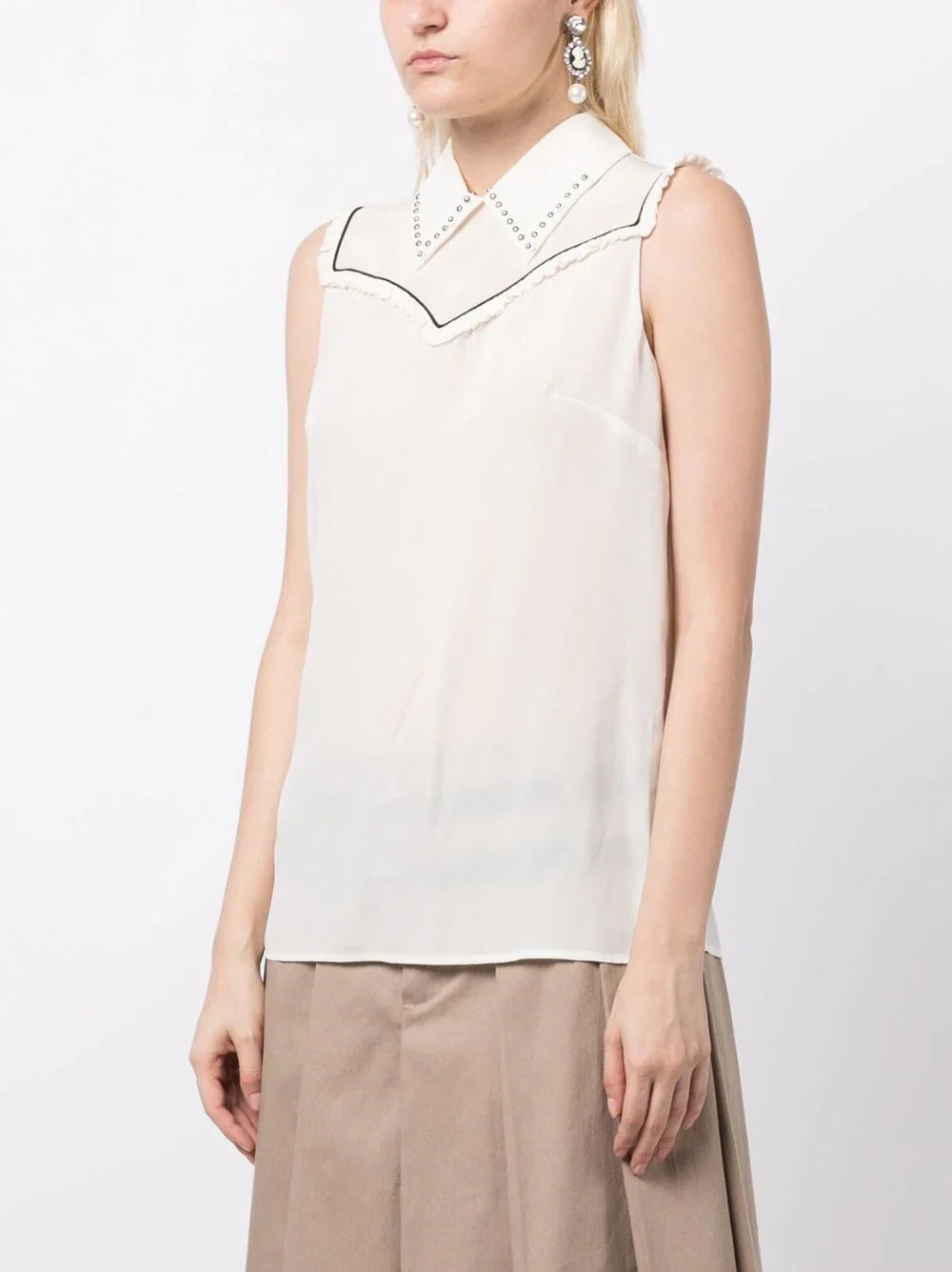 Miu Miu studded sleeveless blouse featuring a stylish design with metal embellishments on a light fabric.