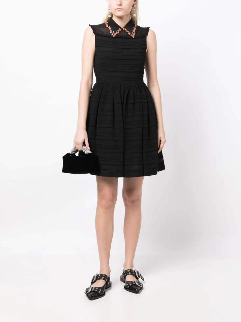 Miu Miu collar-embellished sleeveless dress with decorative details, showcased on a hanger against a neutral background.