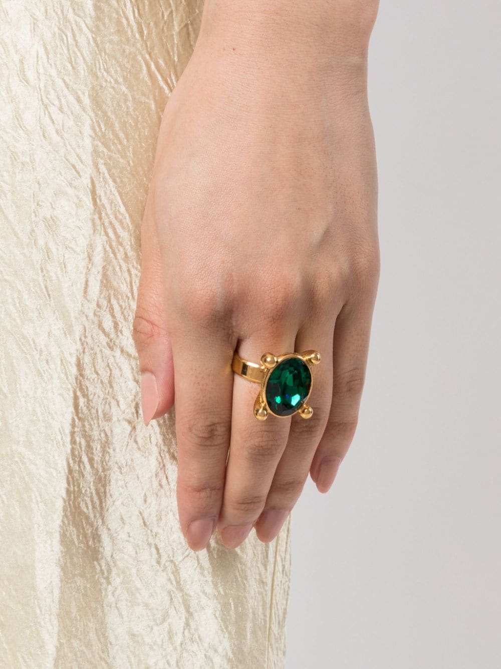 Saint Laurent emerald oval ring with a silver band, featuring a large vibrant emerald gemstone in an oval setting.