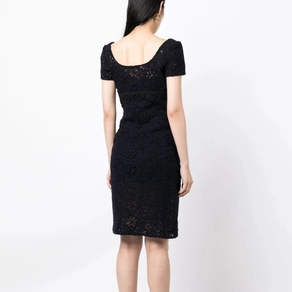 Prada floral lace empire waist dress with a fitted bodice and flowing skirt, perfect for elegant occasions.