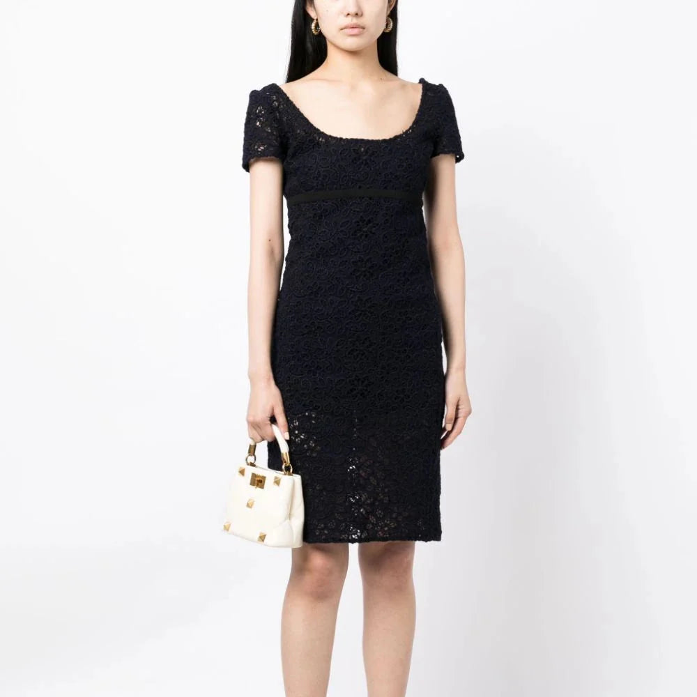 Prada empire waist floral lace dress with a fitted bodice and flowing skirt, showcasing intricate lace details and elegant design.