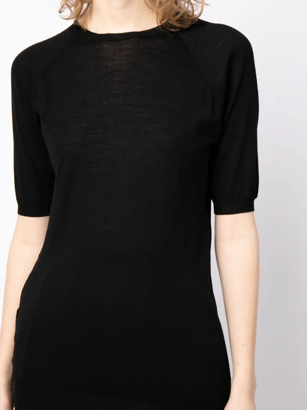 Prada short-sleeved wool knit T-shirt in neutral color, showcasing a close-up of the textured fabric and classic design.
