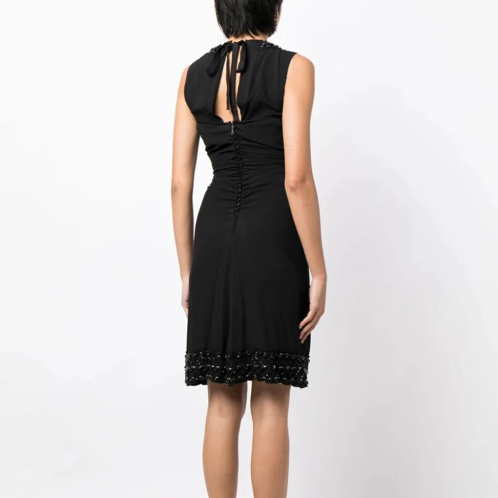 Prada ruched sleeveless dress with a fitted corset-style bodice and elegant design, perfect for stylish occasions.