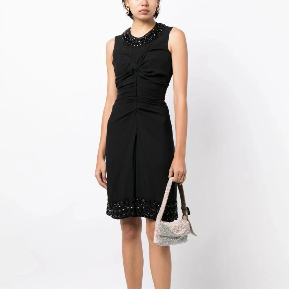 Prada sleeveless dress with ruched corset style, fitted bodice, and elegant design, perfect for formal or stylish occasions.