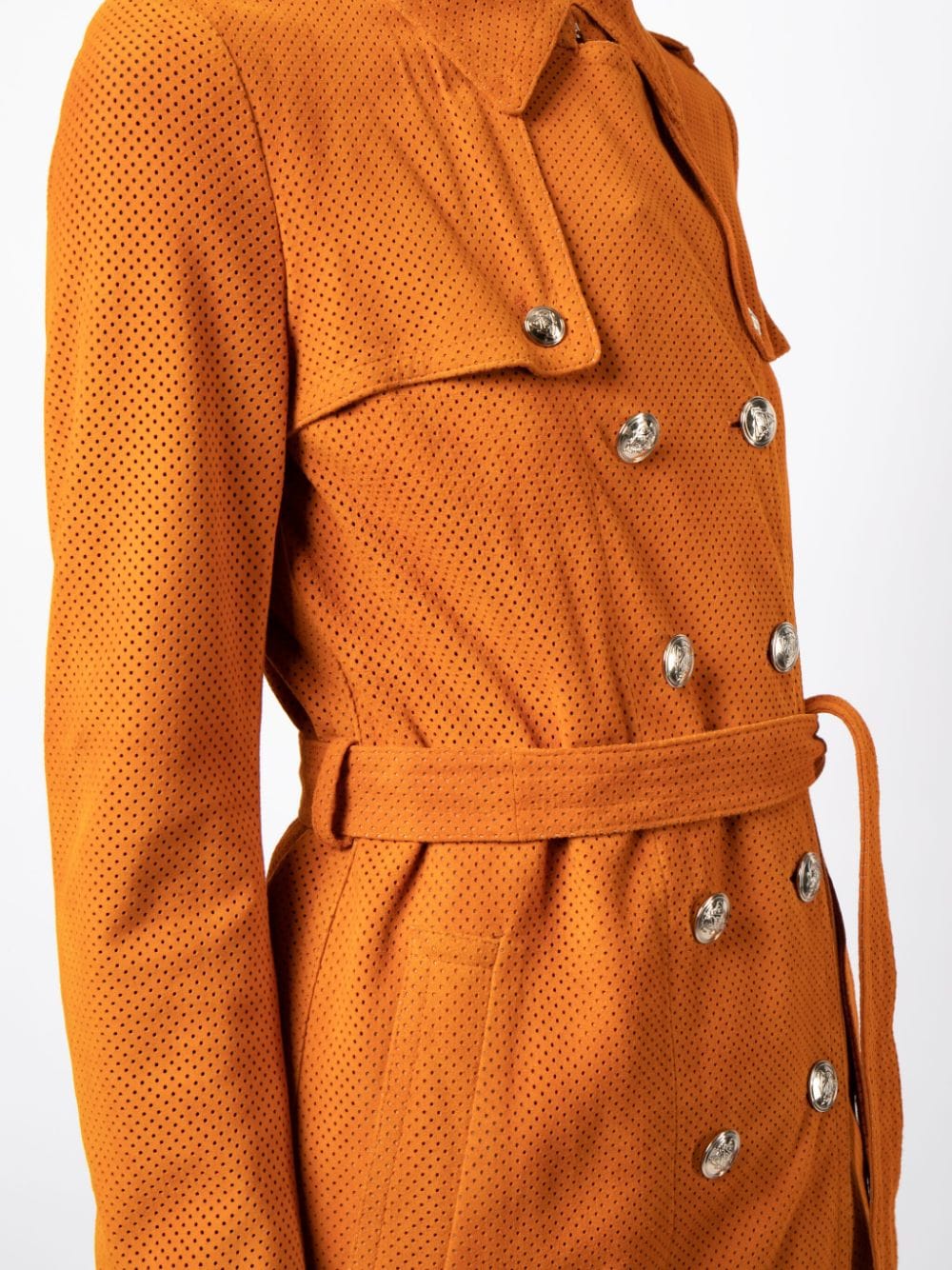 Gucci suede trench coat hanging on a wooden hanger, showcasing its classic design and rich texture.