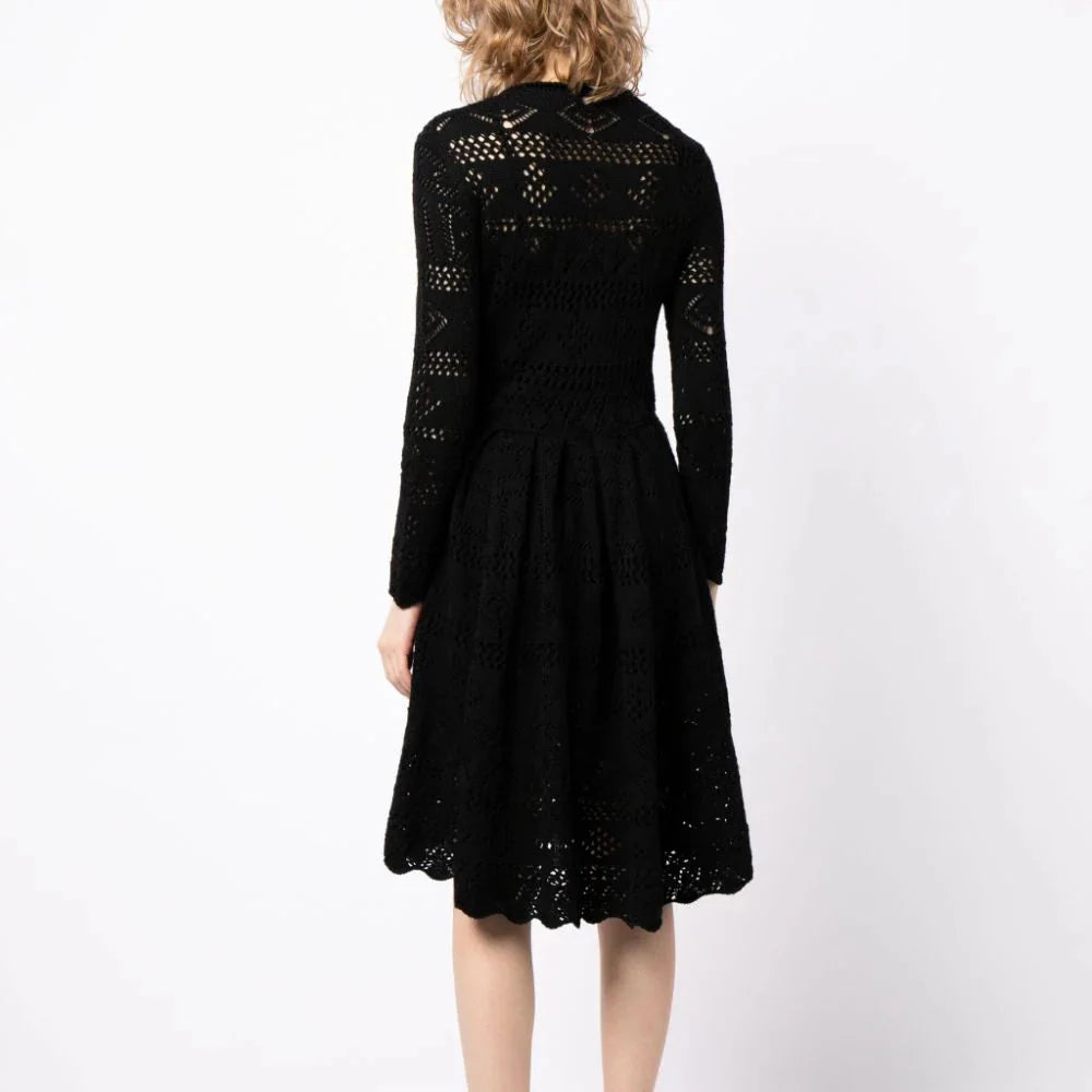 Prada long-sleeved crochet knit dress featuring intricate patterns and a fitted silhouette, modeled on a person.