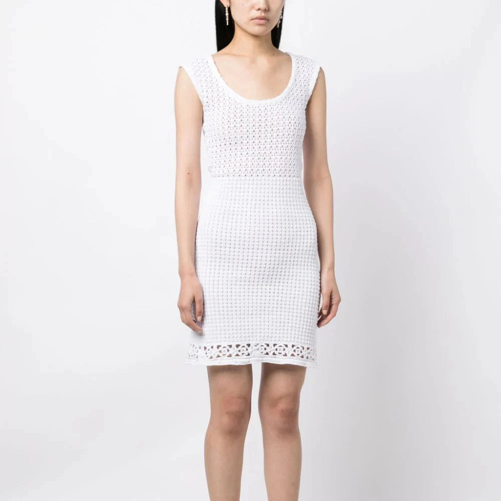 White Prada crochet knit dress with intricate crochet pattern, sleeveless design, and lightweight fabric perfect for summer wear.