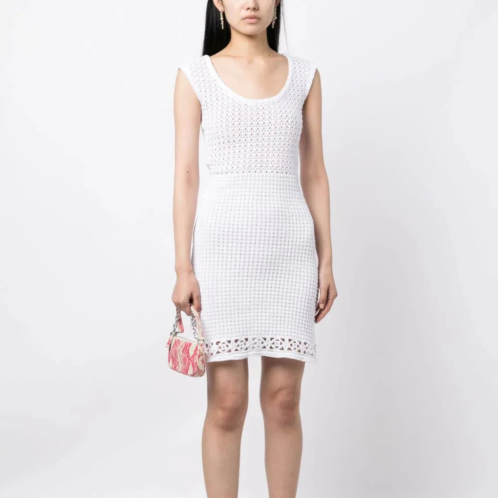 Prada white crochet knit dress, lightweight and stylish, shown on a model with intricate crochet pattern and feminine fit.