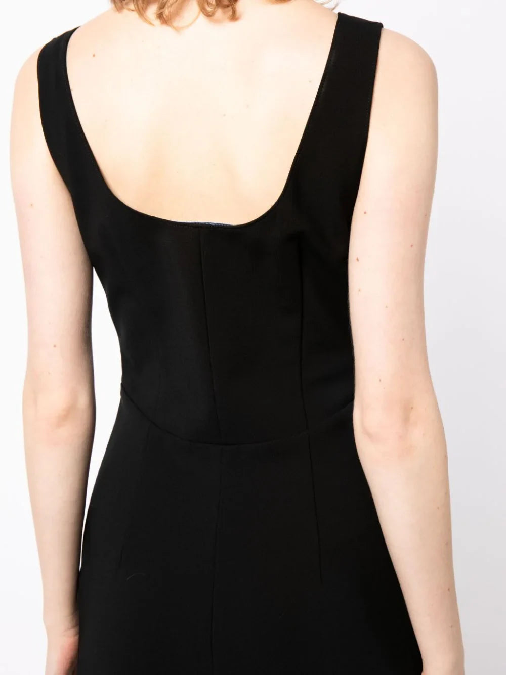 Prada scoop back sleeveless dress featuring a fitted silhouette and elegant design, shown in a stylish fashion image.