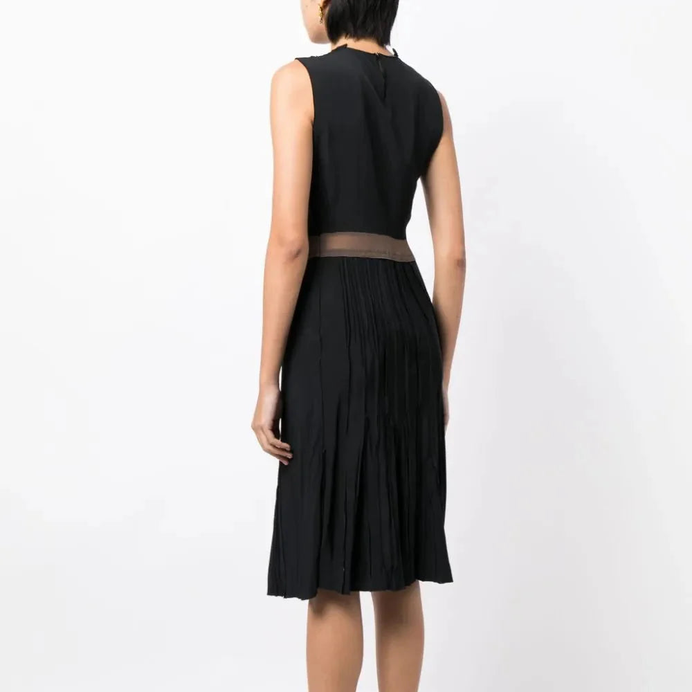 Prada pleated sleeveless silk dress with elegant design and flowing fabric, shown on a model with a neutral background.