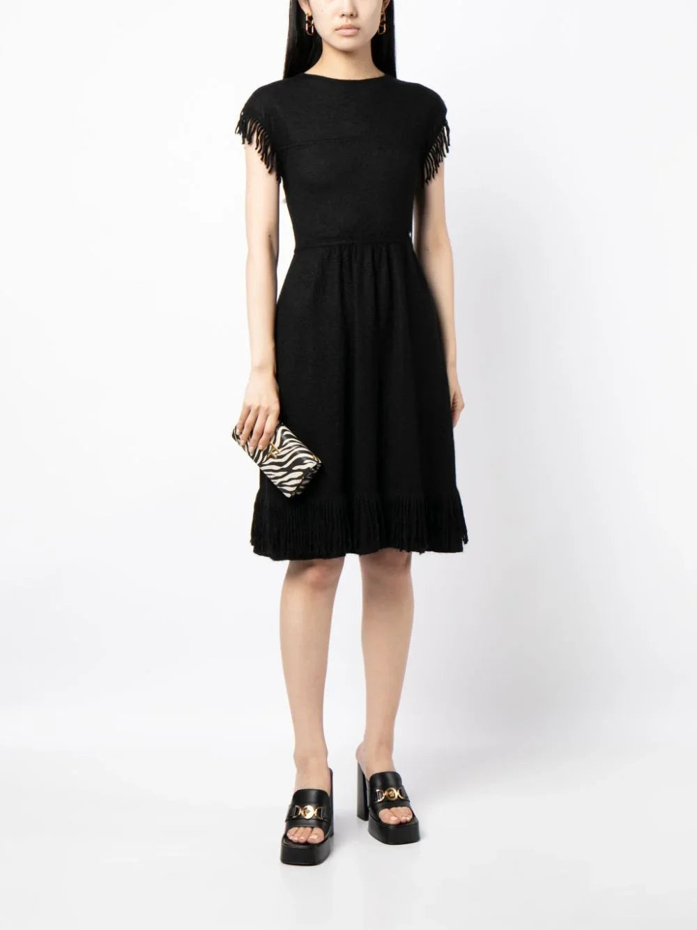Rewind Vintage Affairs fringed knit dress with a bohemian style, featuring a cozy textured fabric and fringed hem detail.