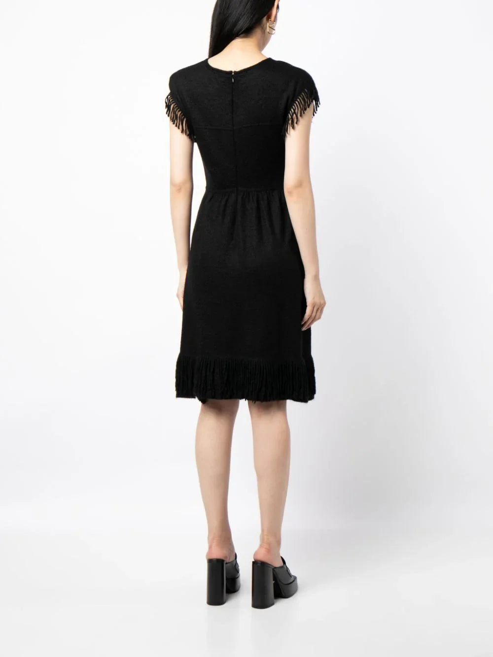 Rewind Vintage Affairs fringed knit dress with a textured pattern and long sleeves, styled with a relaxed fit and boho-inspired design.