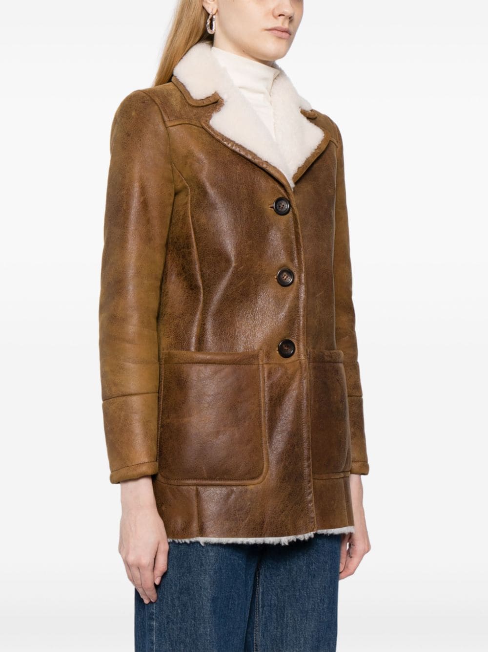 Prada shearling jacket with a cozy, textured exterior and stylish design, perfect for cold weather fashion.