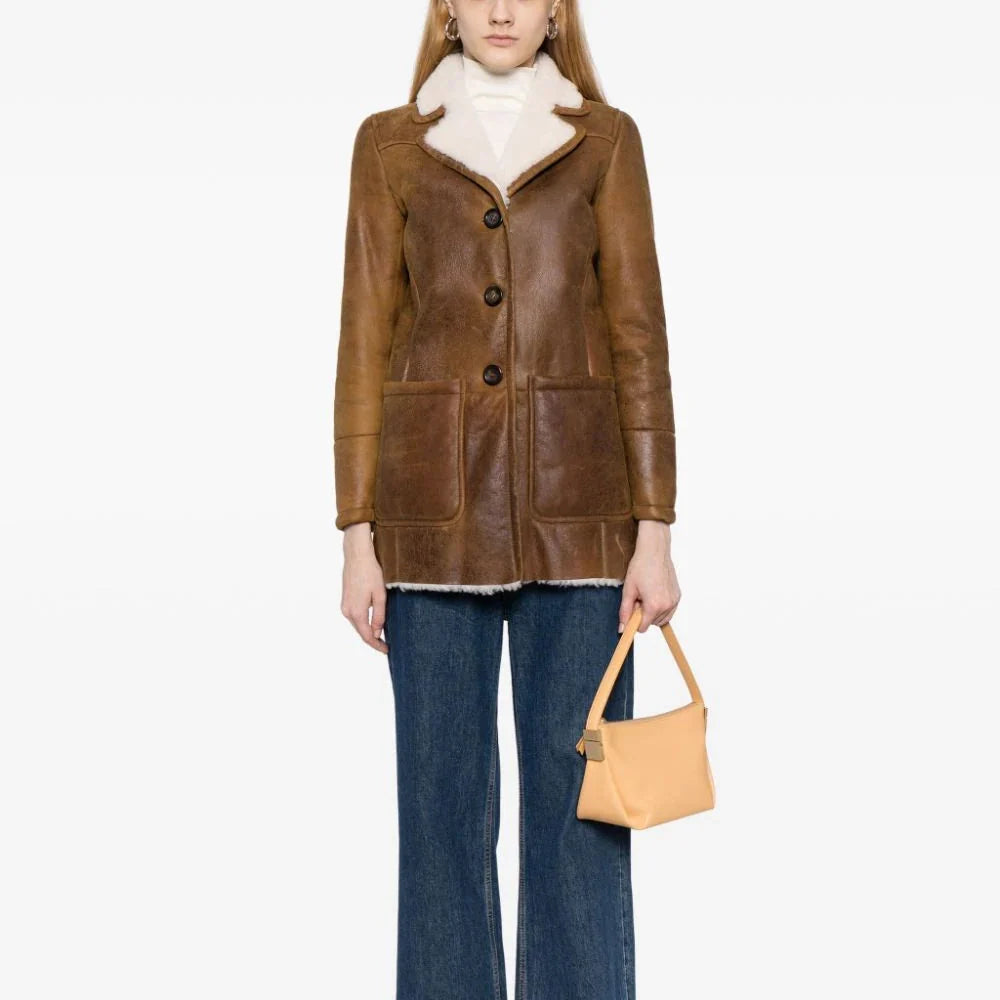 Prada shearling jacket with a soft, plush exterior, tailored fit, and stylish collar, ideal for cold weather.