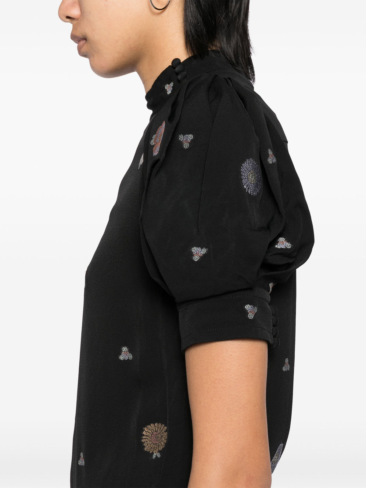 Black embroidered high-neck top by Chloé, featuring intricate embroidery and a stylish high neckline, shown on a model.