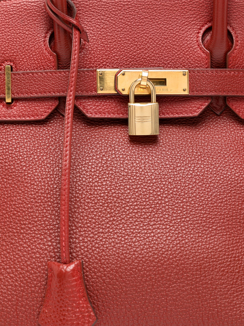 Hermès Birkin 30 Brique Togo GHW top handle bag with gold hardware, showcasing its smooth leather texture and structured design.