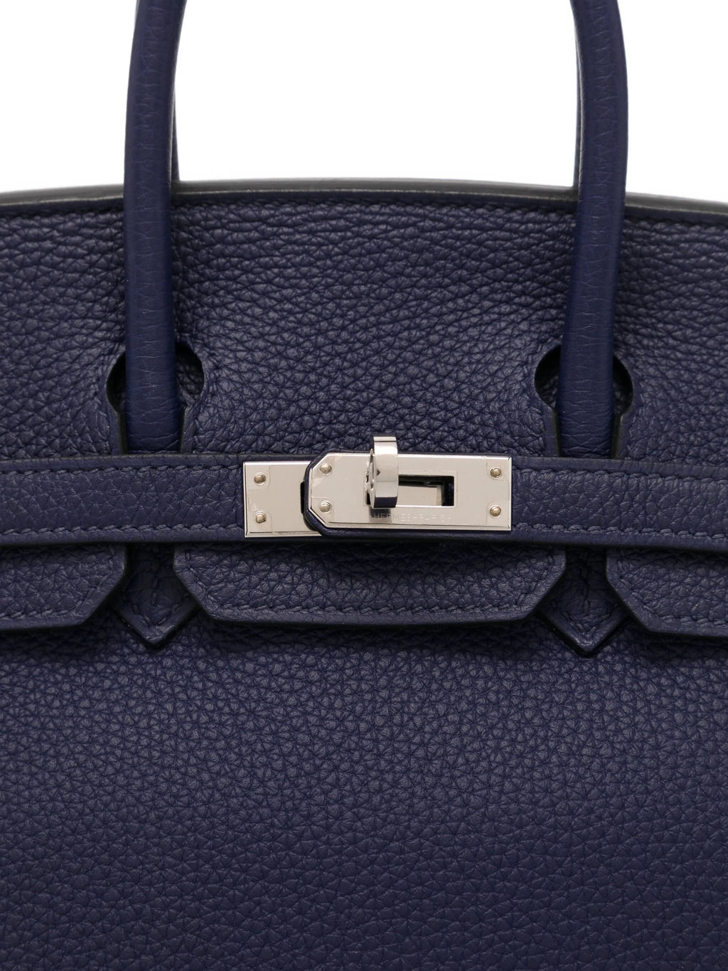 Hermès Birkin 25 Retourne blue sapphire Togo leather top handle bag with gold hardware, showcasing its elegant design and craftsmanship.