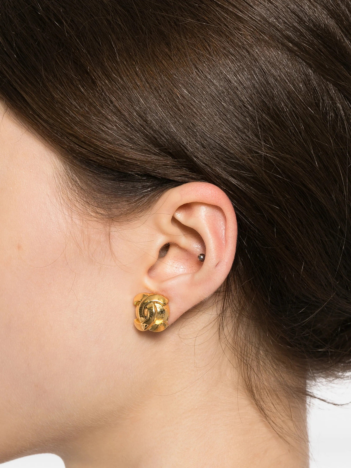 Chanel CC gold clip-on round earrings with smooth shiny finish, stylish jewelry accessory for elegant outfits.