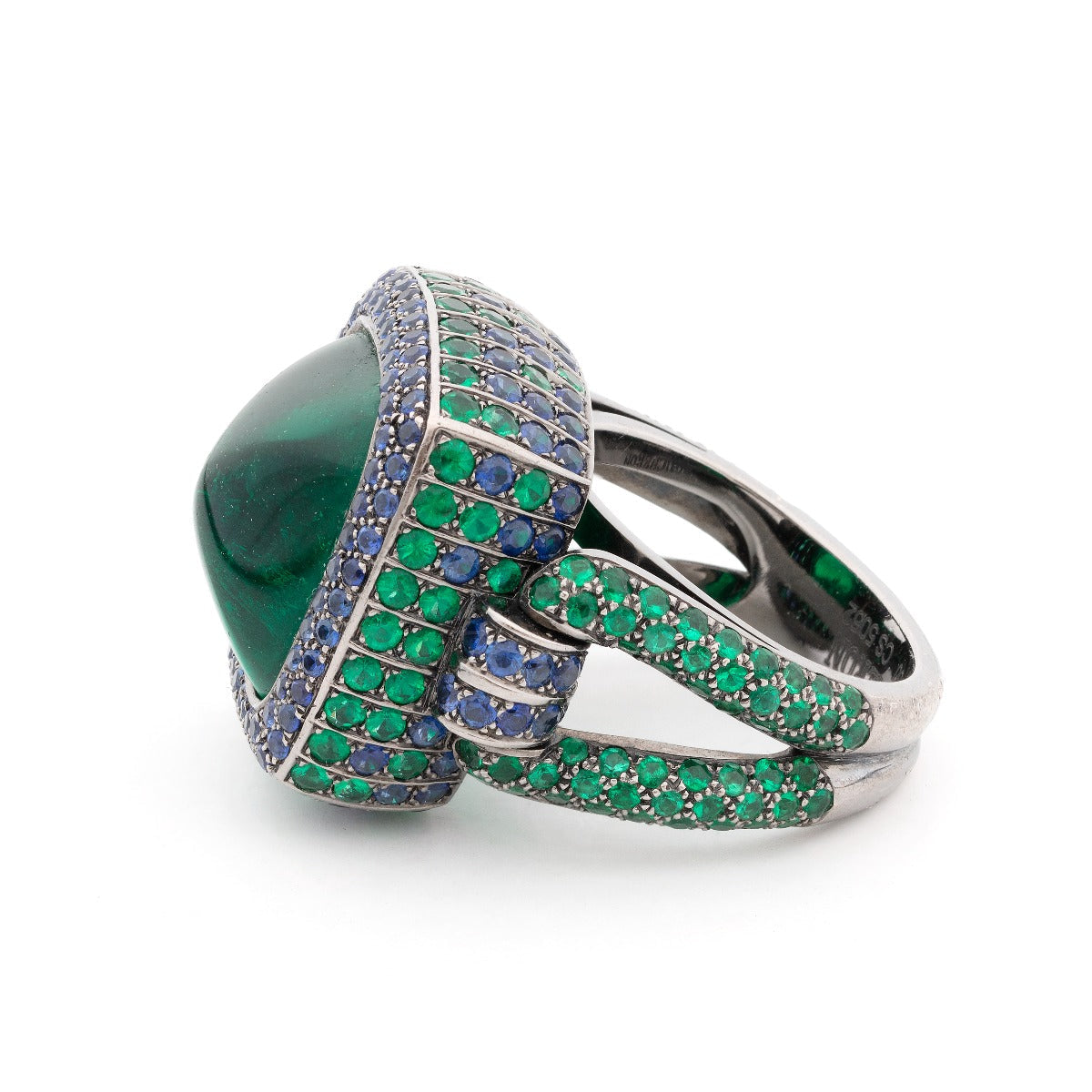 Boucheron 15kt emerald and sapphire ring featuring a detailed gold band with vibrant green and blue gemstones.