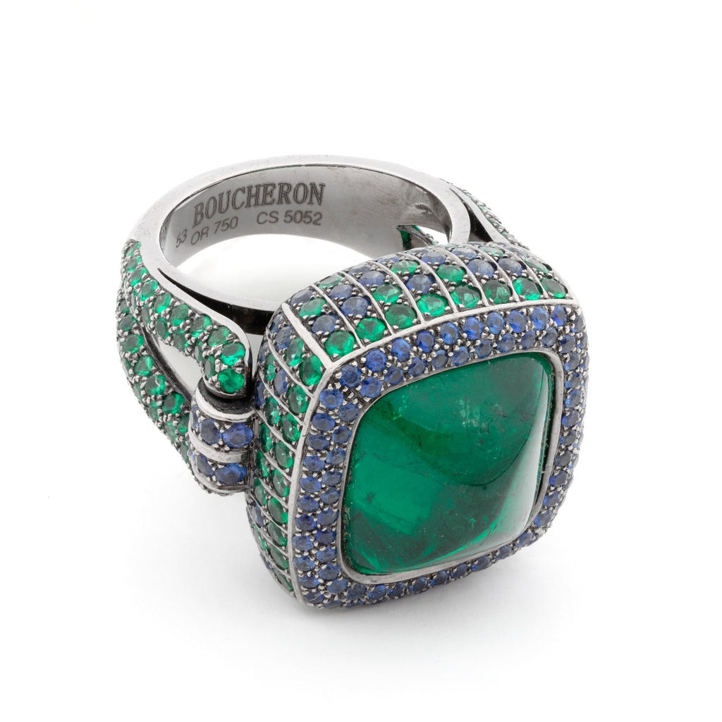 15kt emerald and sapphire ring by Boucheron featuring a vibrant emerald and deep blue sapphires set in a luxurious ring design