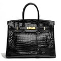 Hermès Birkin 35 Black GHW top handle bag with gold hardware, showcasing luxurious leather craftsmanship.