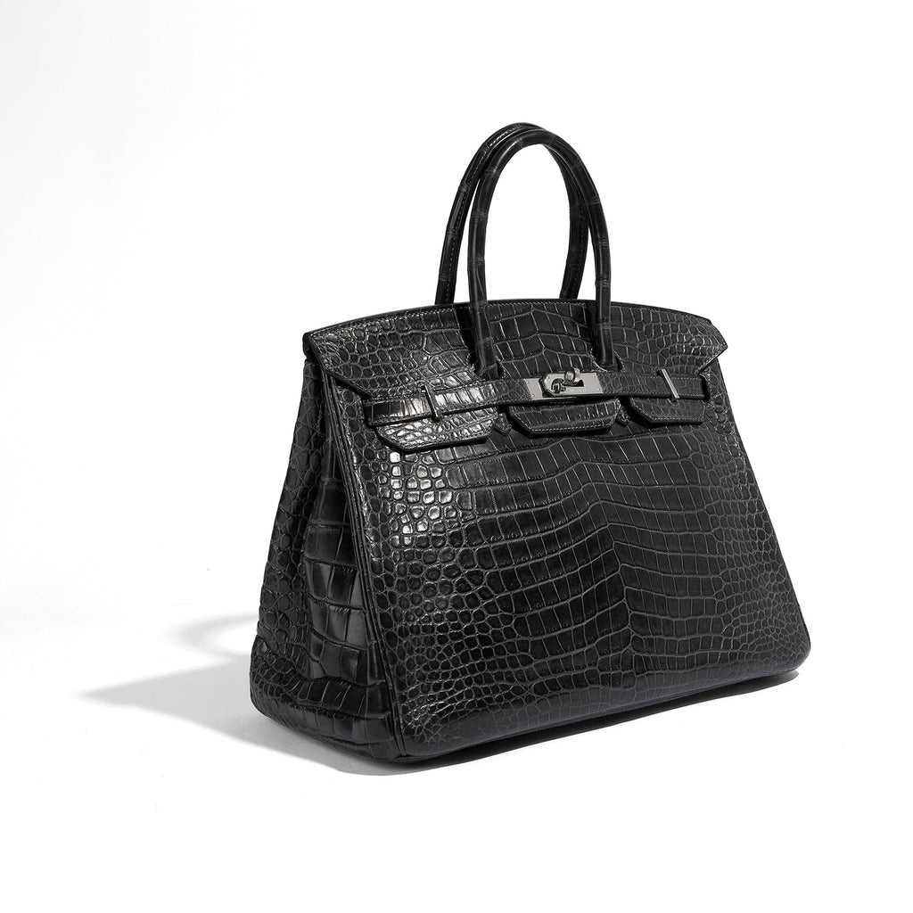 Hermès Birkin 35 grey PHW top handle bag displayed on a plain background, showcasing its elegant design and top handle details.
