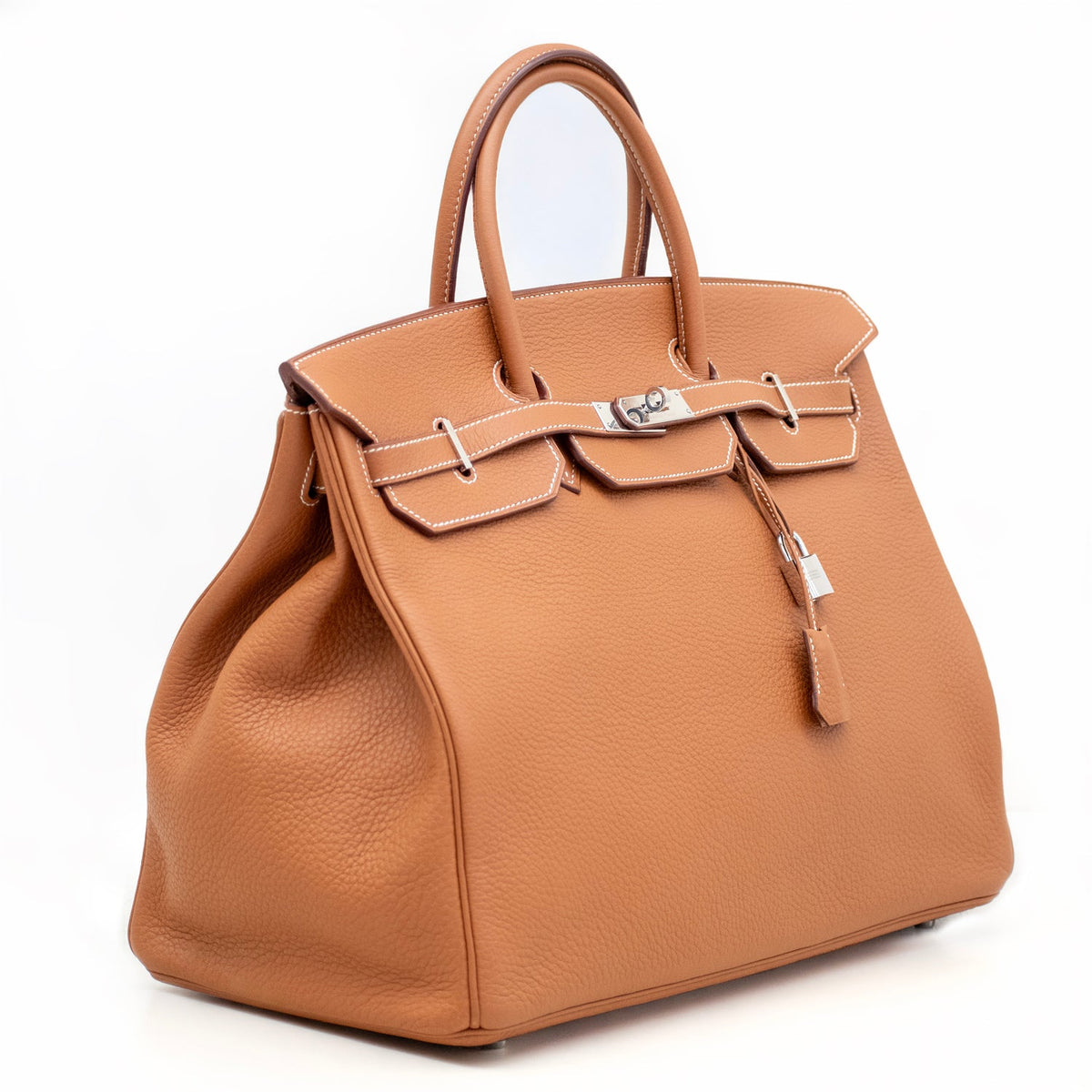 Hermès Birkin 40 Gold Togo PHW top handle bag shown from the side, featuring luxurious gold hardware and structured design.