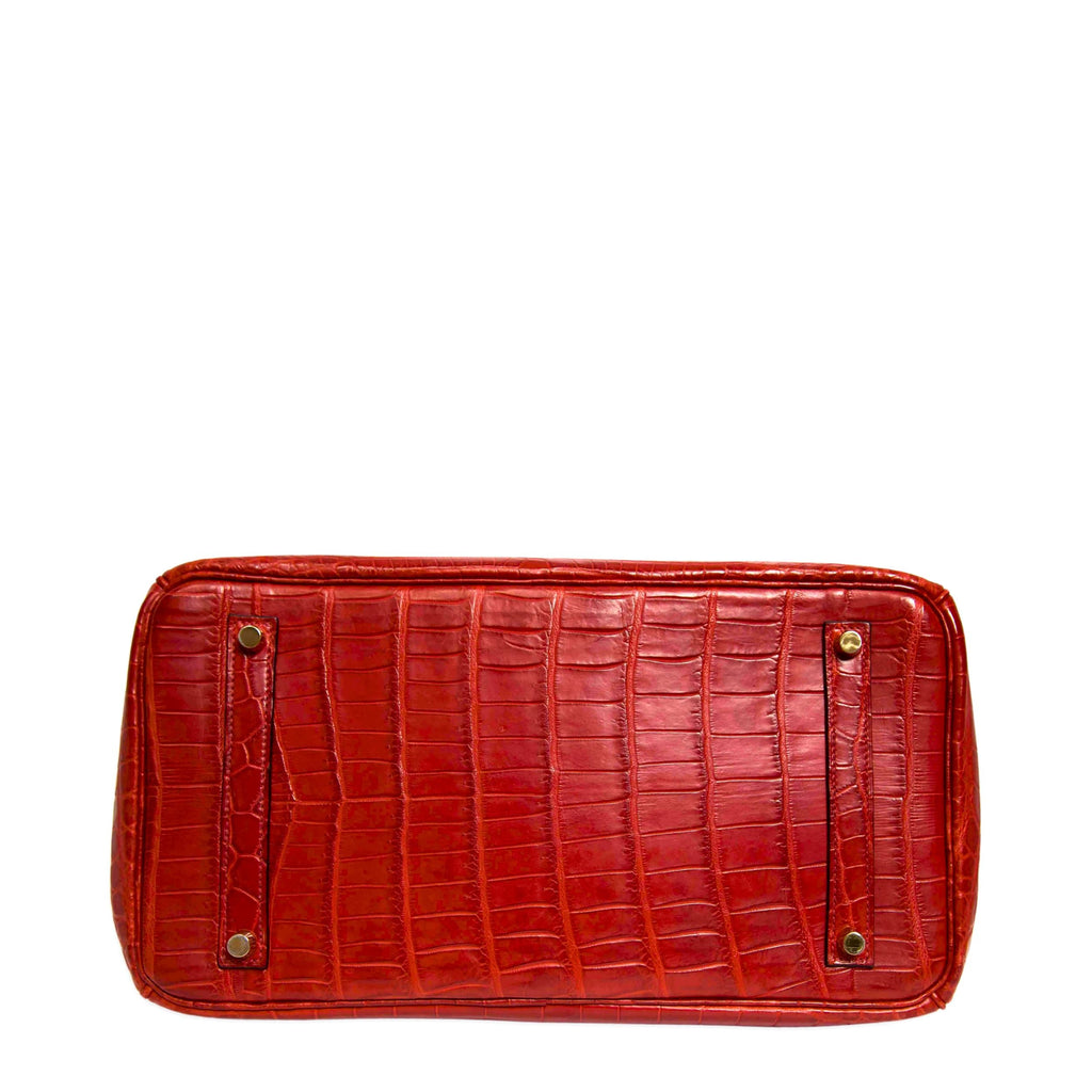 Hermès Birkin 35 red GHW top handle bag with gold hardware, showing the bottom view and luxurious leather texture.