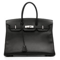 Hermès Birkin 35 black Togo leather top handle bag with palladium hardware, showcasing its structured design and luxurious craftsmanship.
