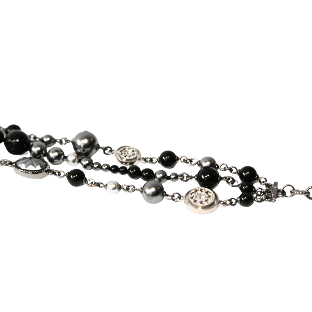 Chanel CC charm beaded bracelet featuring elegant beads and signature logo charm, stylish accessory for wrist.