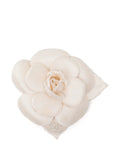 Chanel 2019 Camellia CC brooch featuring a floral design with gold and enamel accents, displayed on a neutral background.