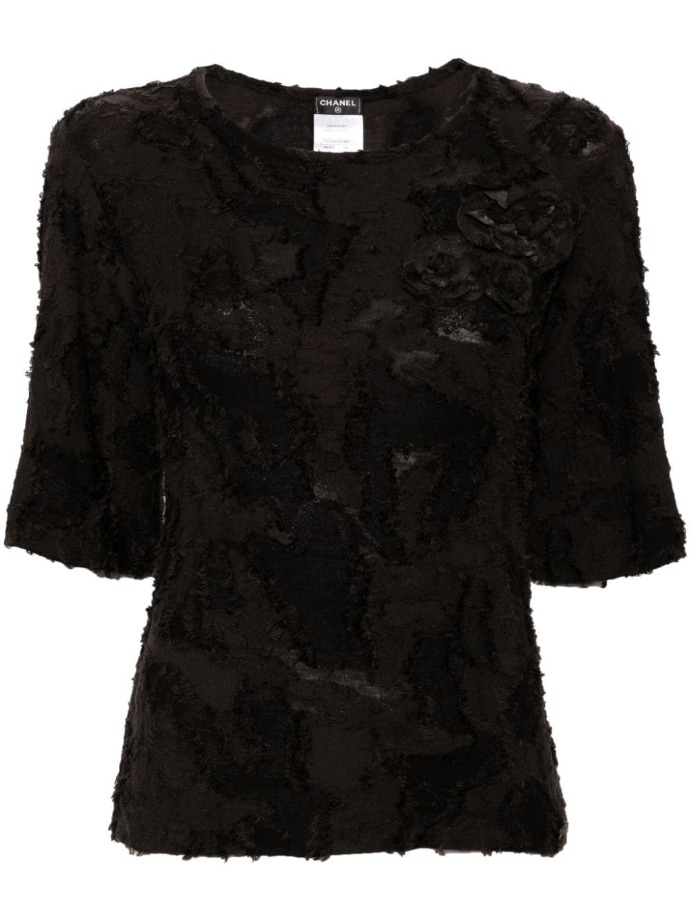 Chanel black cotton top with three decorative brooches, stylish and elegant fashion piece for women.