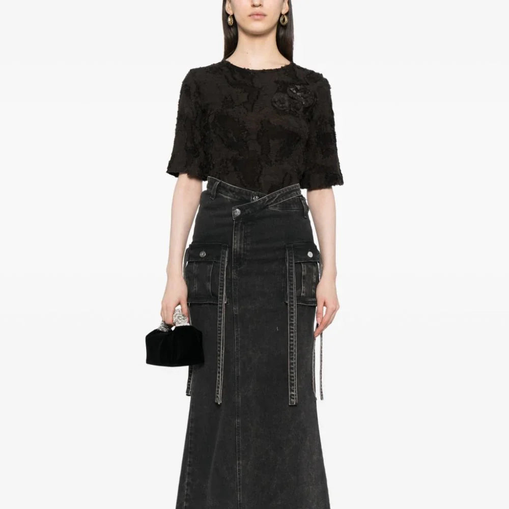 Black Chanel cotton top featuring three elegant brooches, stylish and comfortable for sophisticated casual wear.
