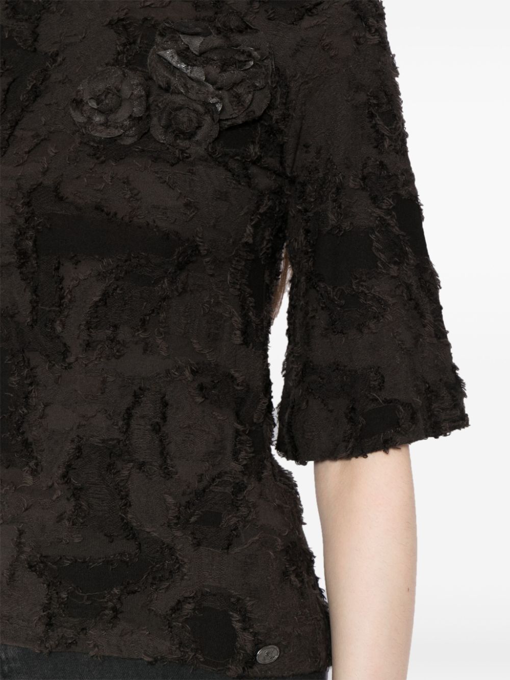 Chanel black cotton top featuring three decorative brooches, stylish and elegant women's fashion apparel.