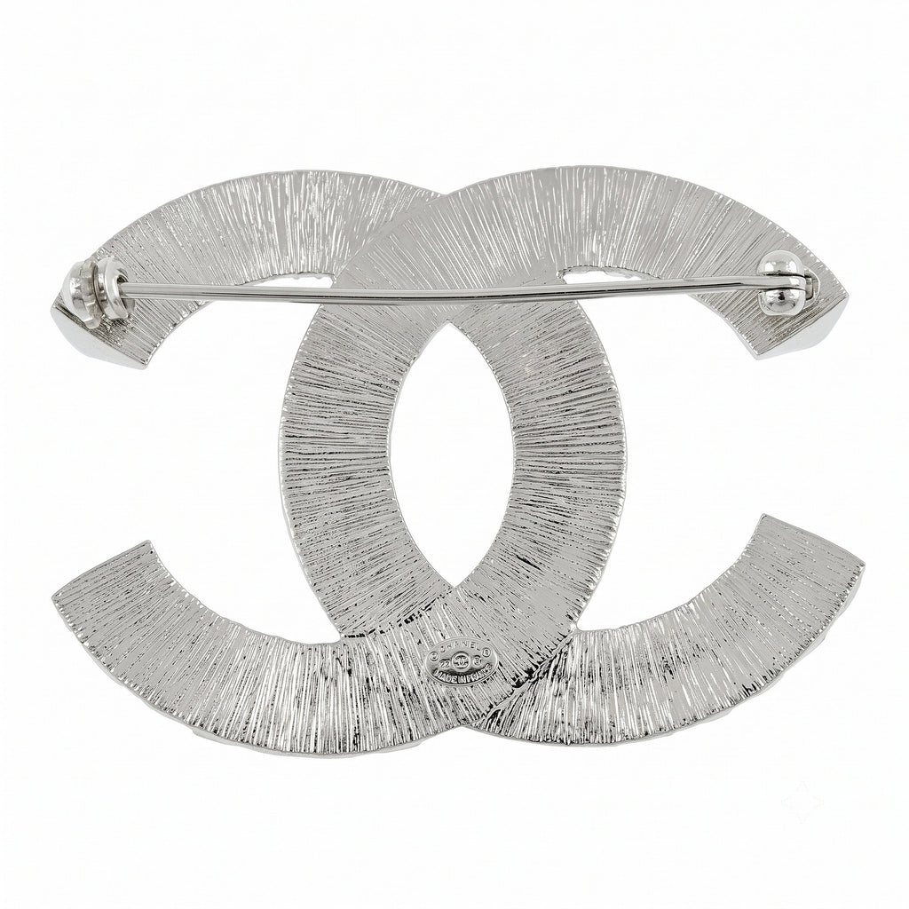 Chanel crystal pin brooch with sparkling detailing and elegant design, shown from the back with pin fastening.