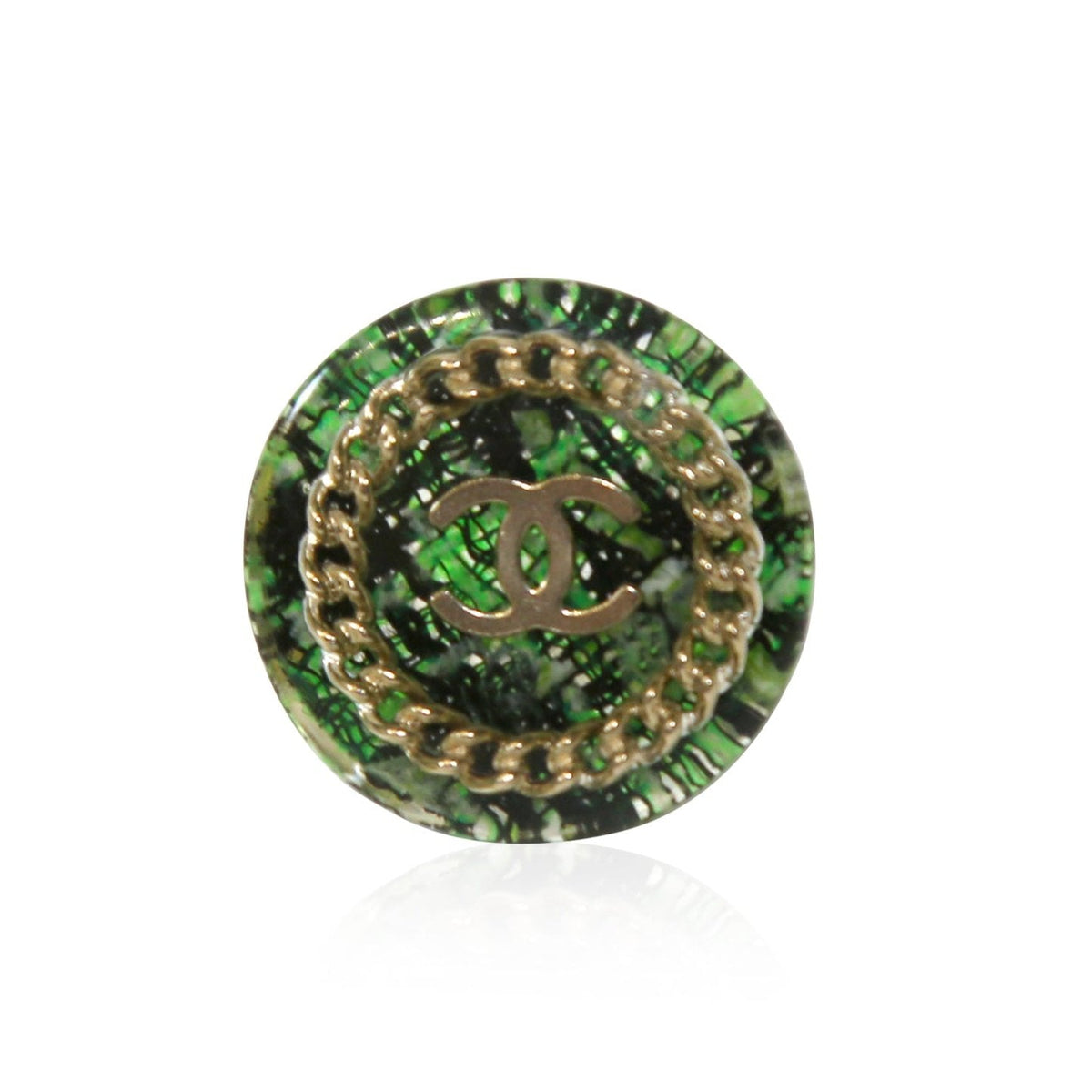 Green tweed Chanel ring featuring a stylish design, showcasing the textured fabric and elegant craftsmanship.
