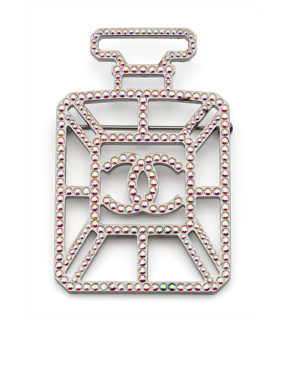 Iridescent Chanel perfume bottle brooch with CC logo, decorative jewelry accessory, shiny glass-like finish, detailed design.