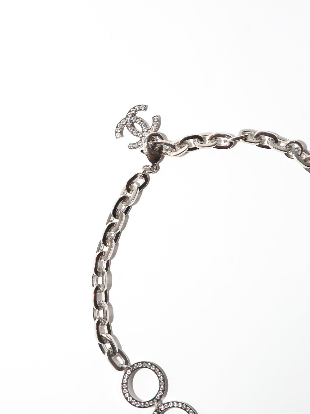 Close-up of Chanel Strass CC silver collar necklace with sparkling crystal embellishments and signature logo design.