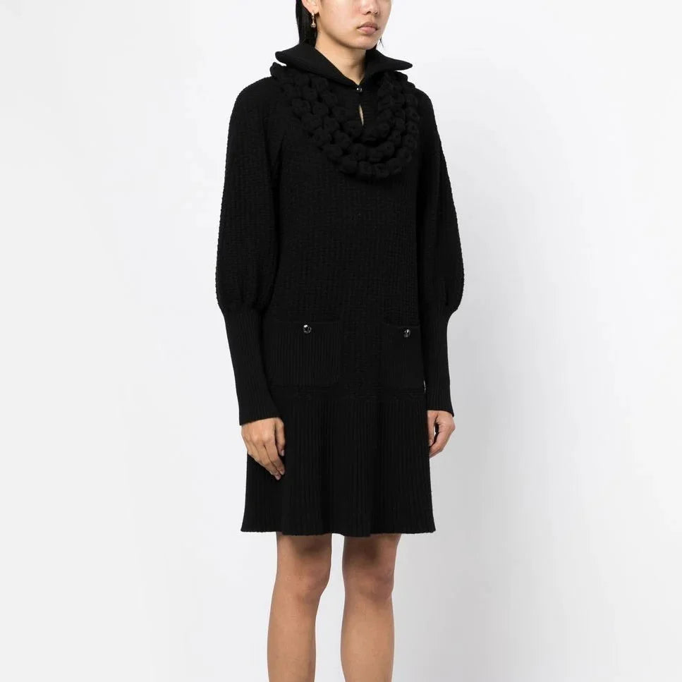 Black textured knit Chanel dress with a collar, showcasing elegant, classic design perfect for sophisticated occasions.