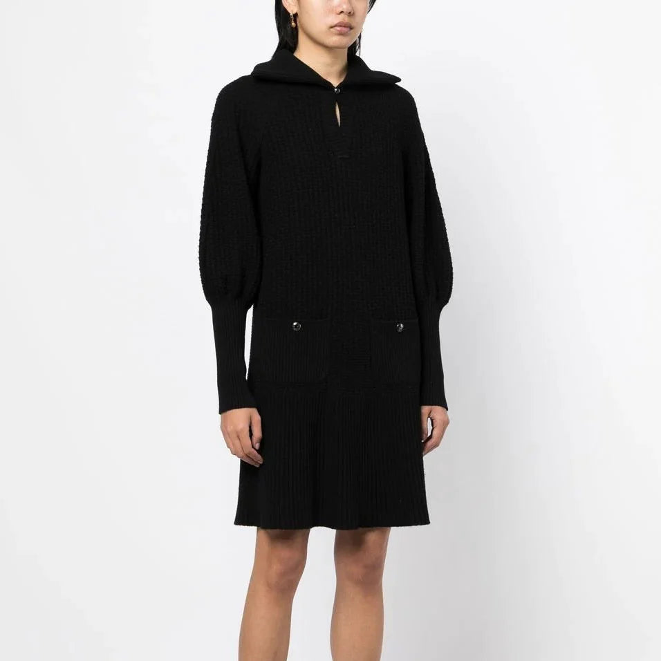 Black Chanel knit collared dress with textured fabric, tailored fit, and classic design, perfect for elegant occasions.