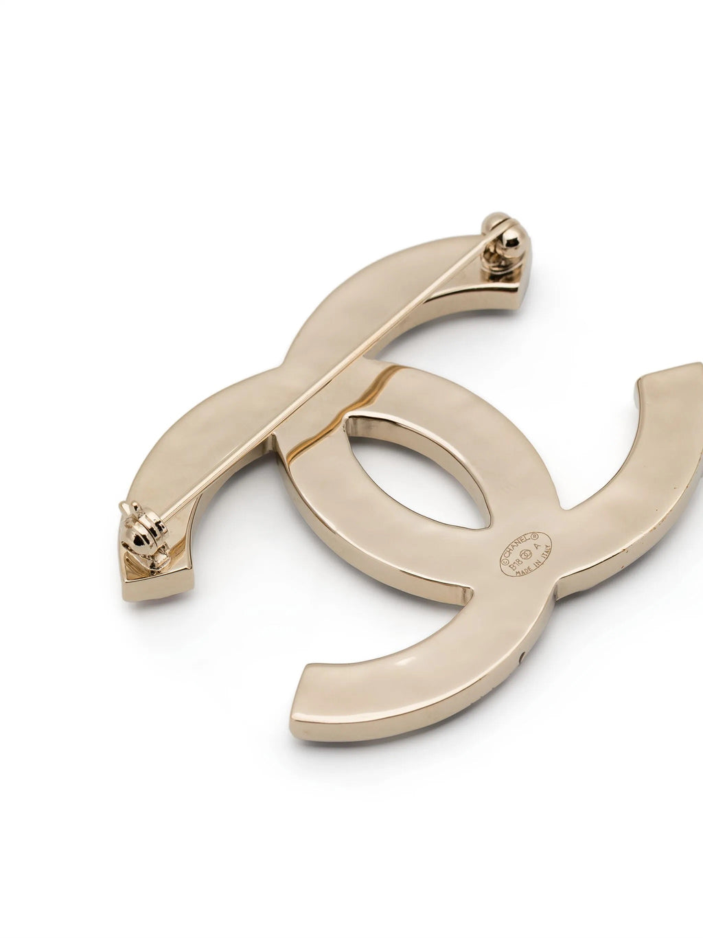 Chanel crystal enamel stripe brooch with colorful designs and gold-tone pin on a white background